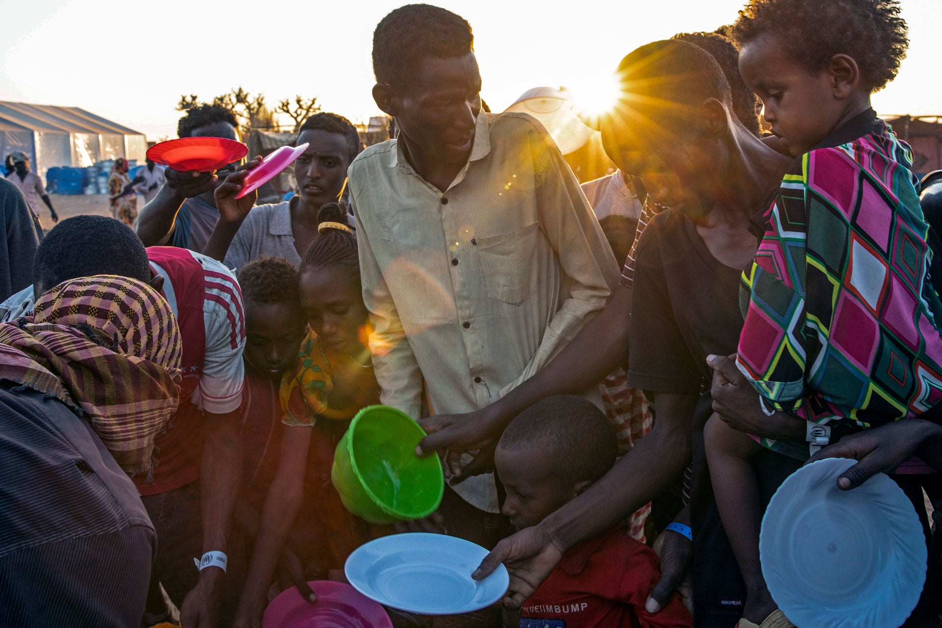 People who fled the conflict in Ethiopia's Tigray region wait for food at Um Raquba refugee camp in al-Gadaref state, eastern Sudan, November 23, 2020. 