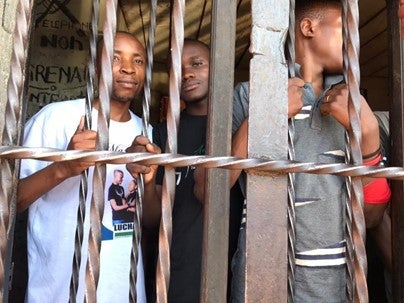 Youth activists Eric Muhindo, left, and Elisée Lwatumba, center, at Butembo’s central prison, eastern Democratic Republic of Congo.