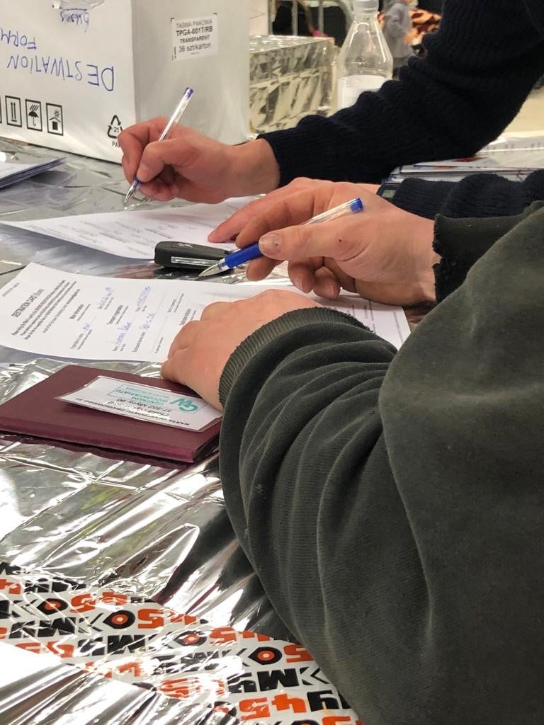 Drivers offering private transport to refugees complete forms in a registration system developed and run by volunteers at a reception center in Korczowa, Poland, March 22, 2022.