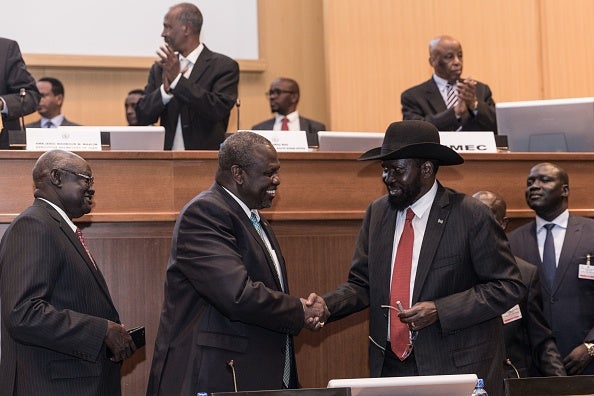South Sudan's President Salva Kiir (2nd R) and his former deputy turned rebel leader Riek Machar (2nd L) shake hands as they make a last peace deal at the 33rd Extraordinary Summit of Intergovernmental Authority on Development (IGAD) in Addis Ababa on September 12, 2018.