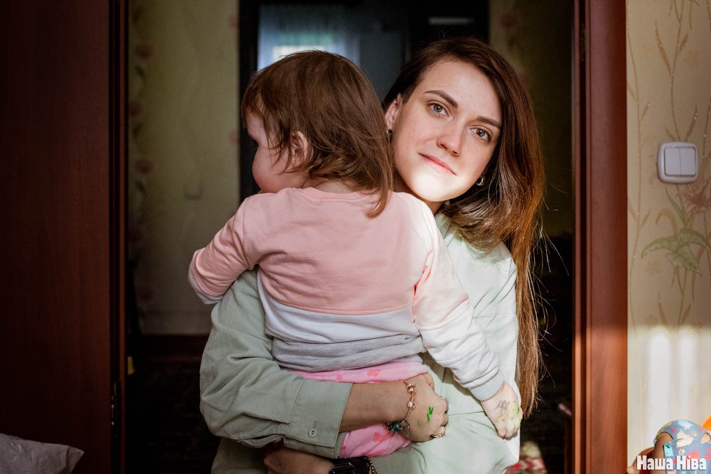 A woman holding her daughter in her arms