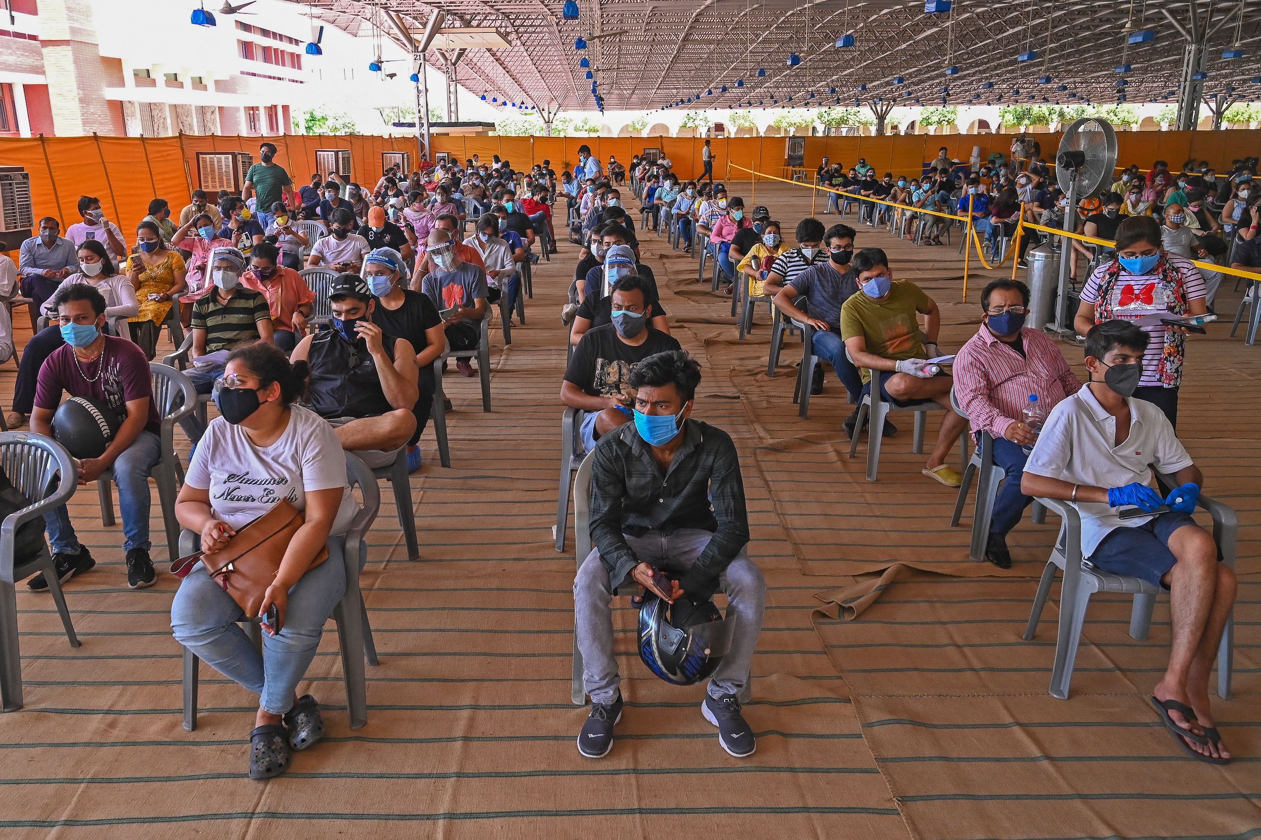 People wait to get a dose of the Covishield vaccine against the Covid-19 coronavirus at the vaccination center of BLK-Max hospital in New Delhi, India.