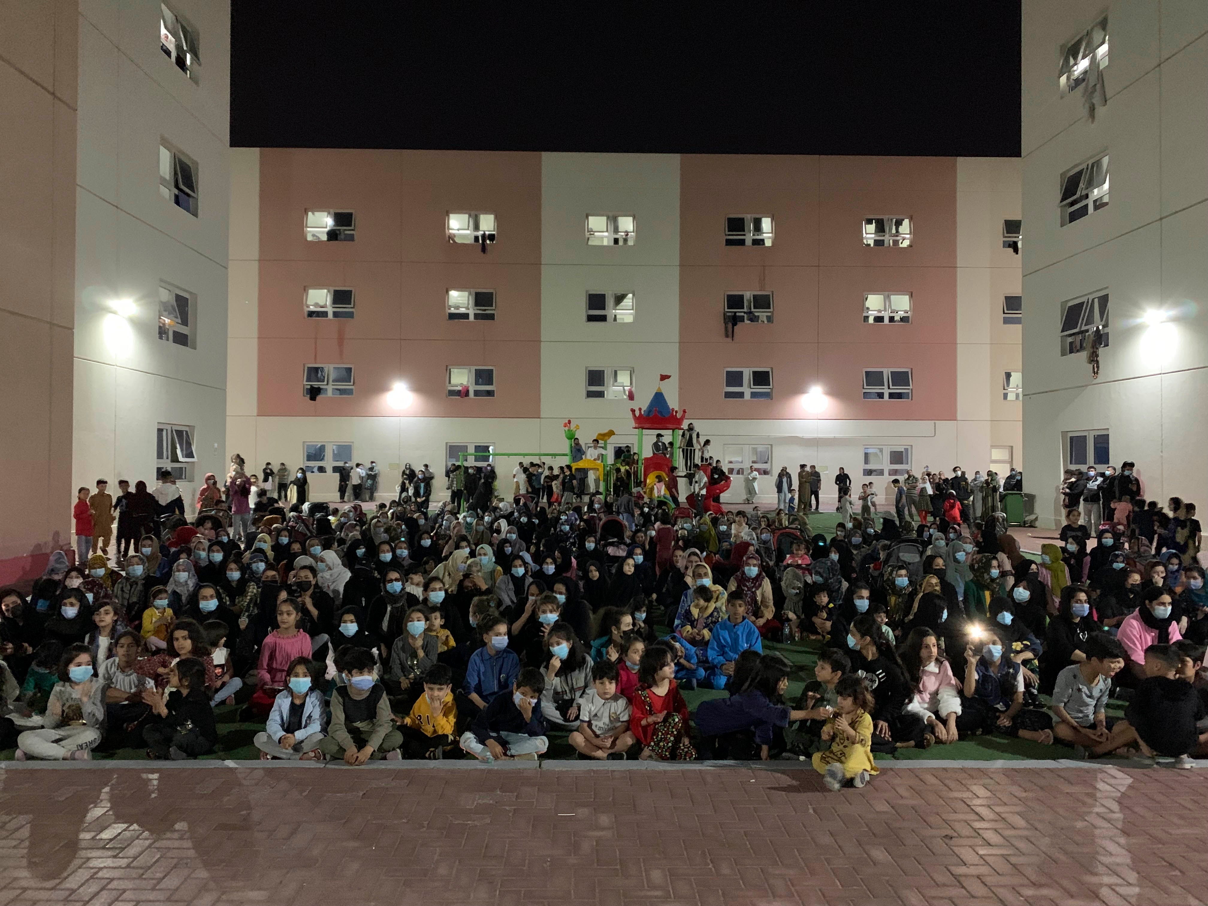 Afghans rally in an Afghan refugee camp in Abu Dhabi, the capital of the United Arab Emirates, to protest their non-transfer to the United States, February 13, 2022.