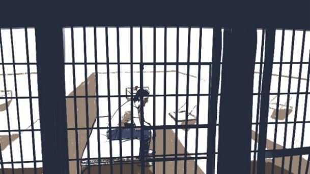 A man sits in a jail cell