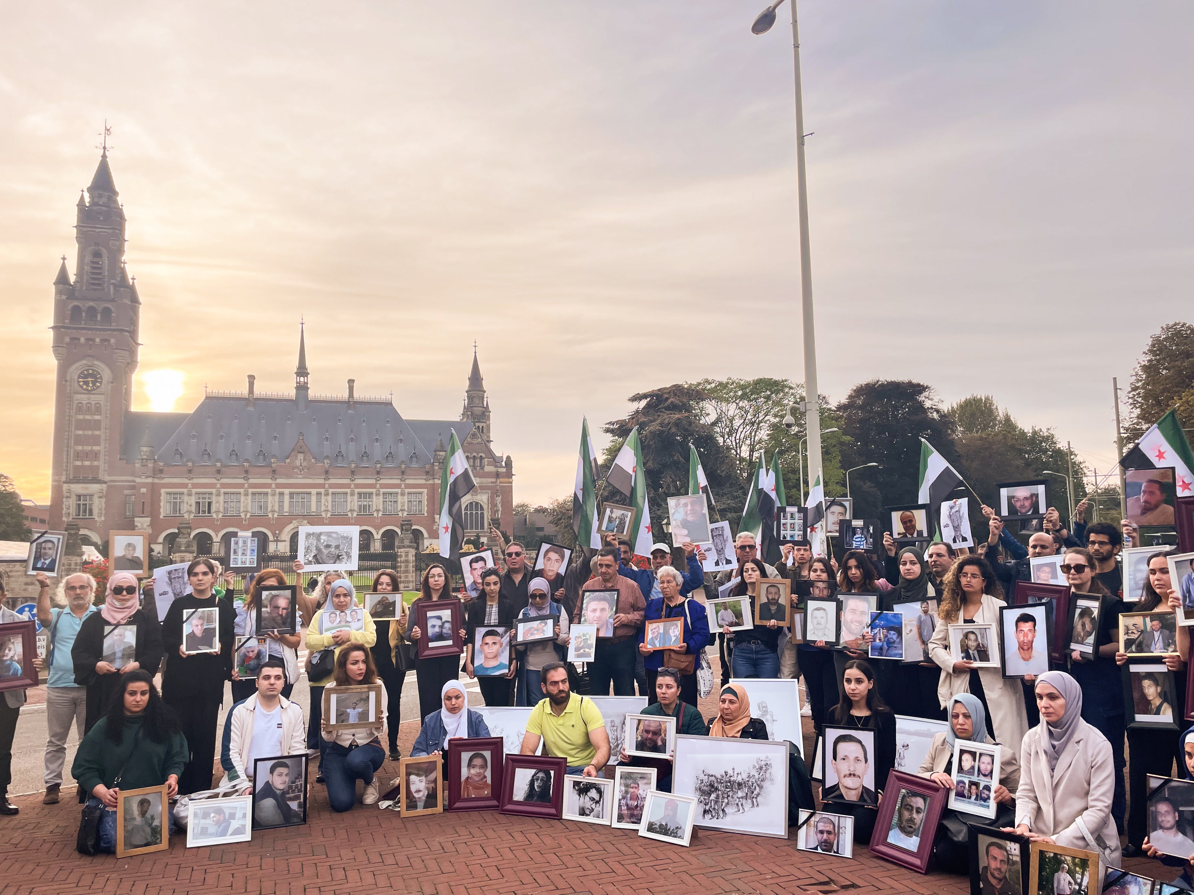 Des membres des familles de Syriens détenus ou disparus dans leur pays, tenant des photos de leurs proches, étaient rassemblés devant le siège de la Cour internationale de justice à La Haye, aux Pays-Bas, le 10 octobre 2023. 