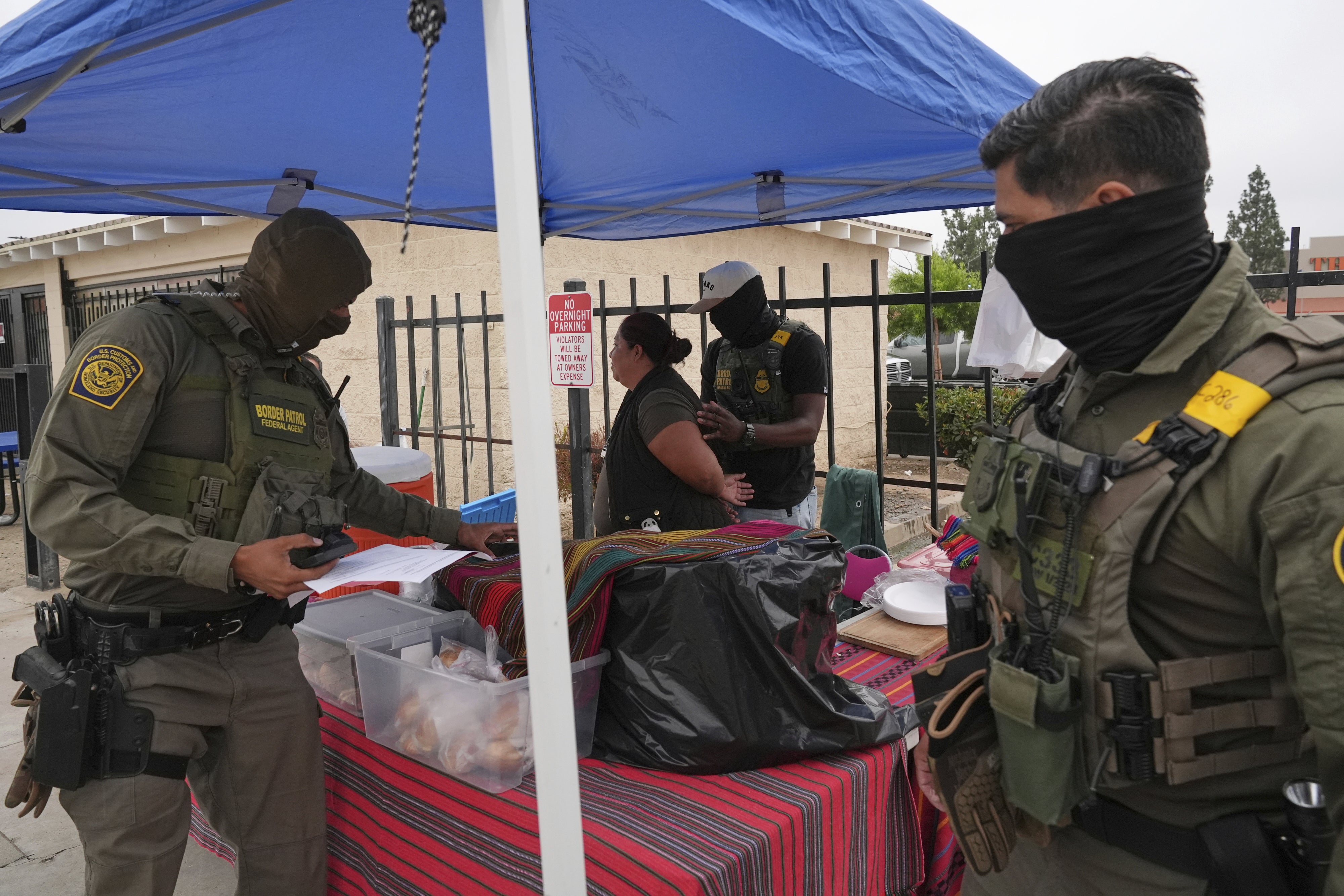 A woman is detained by US Border Patrol agents outside a Home Depot in Los Angeles, California, August 15, 2025.