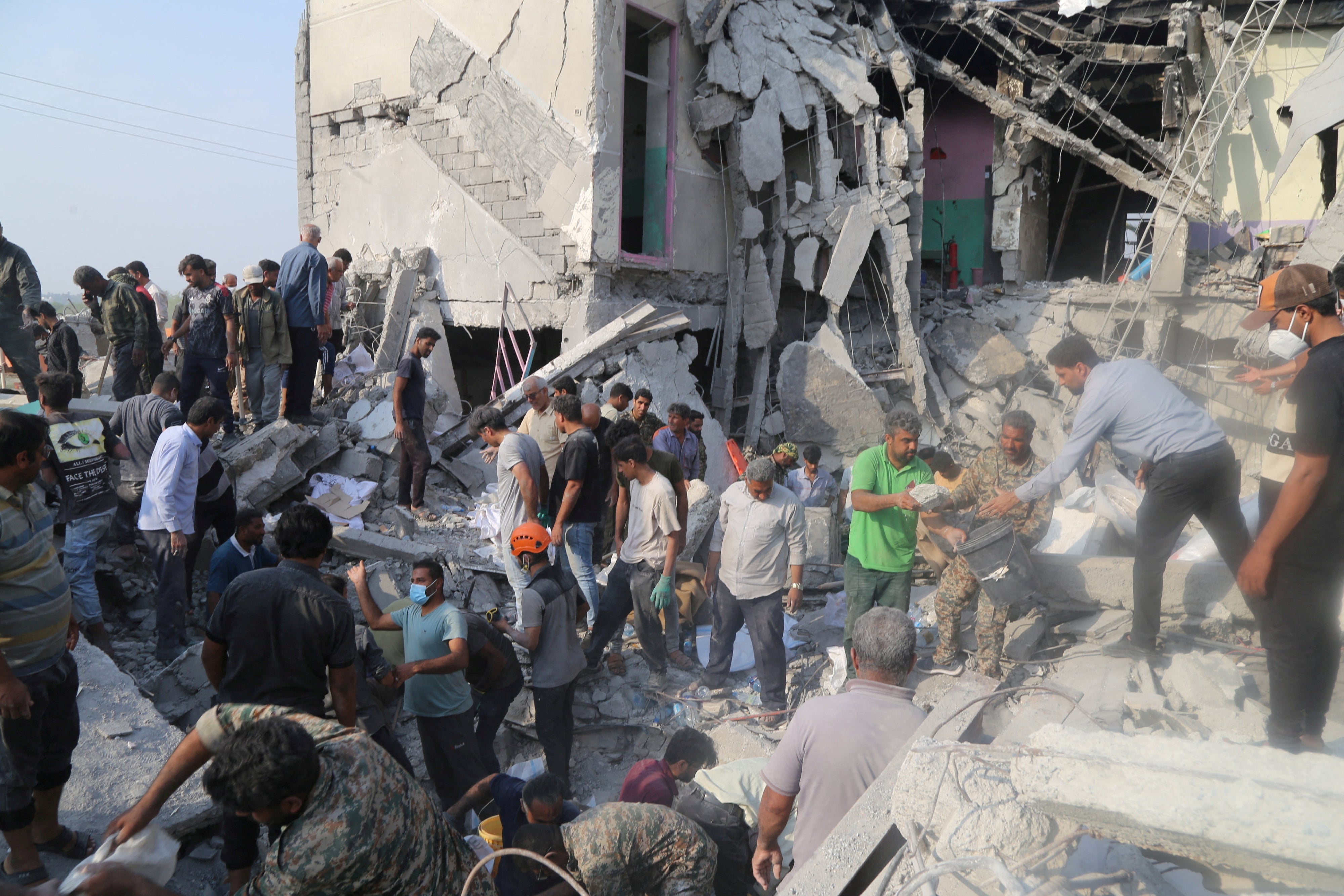 Rescue forces and others at work following a strike on a primary school in Minab, Iran, February 28, 2026. 