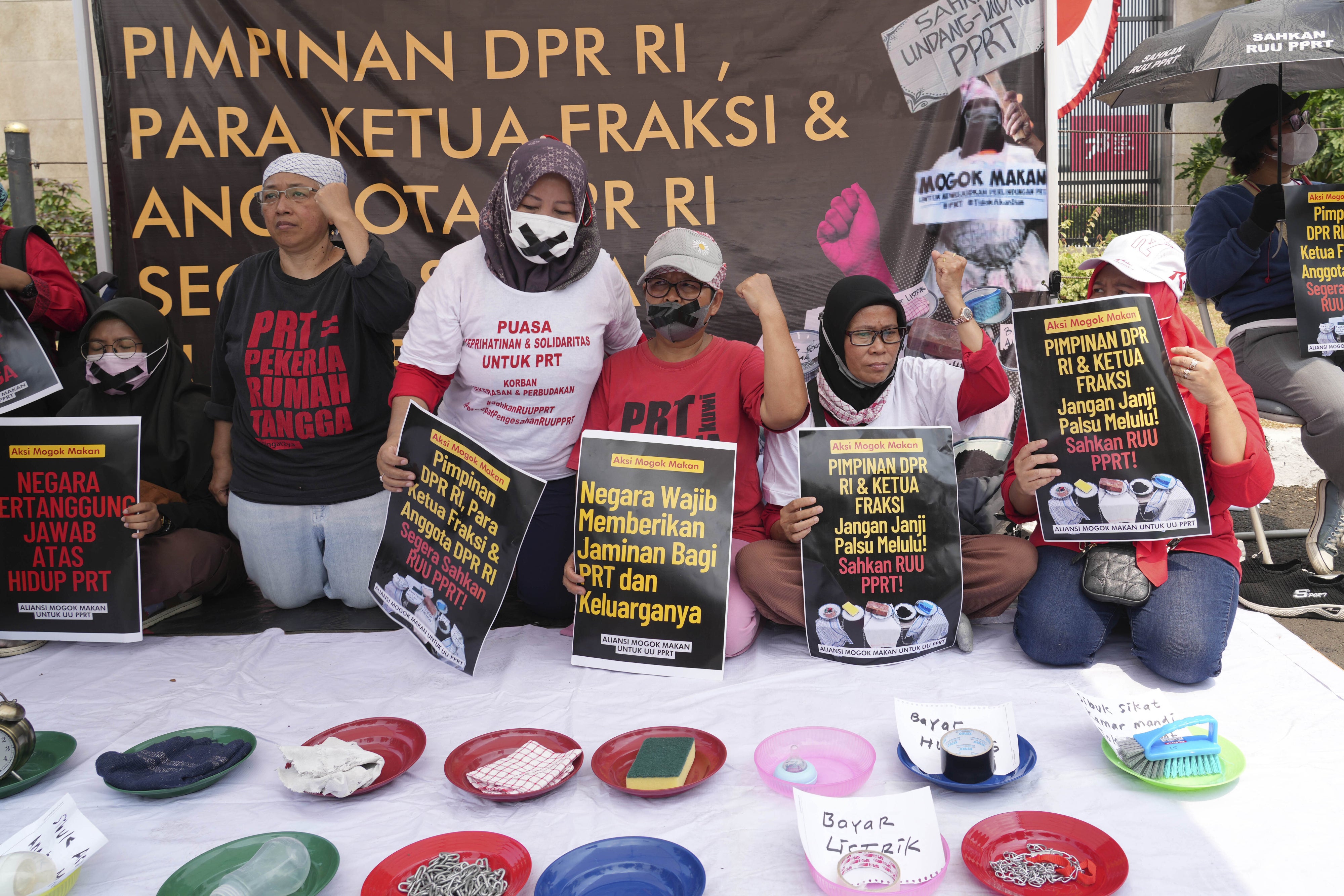 Activists demand the Indonesian parliament pass a bill to protect domestic workers outside the parliament building in Jakarta, August 14, 2023.