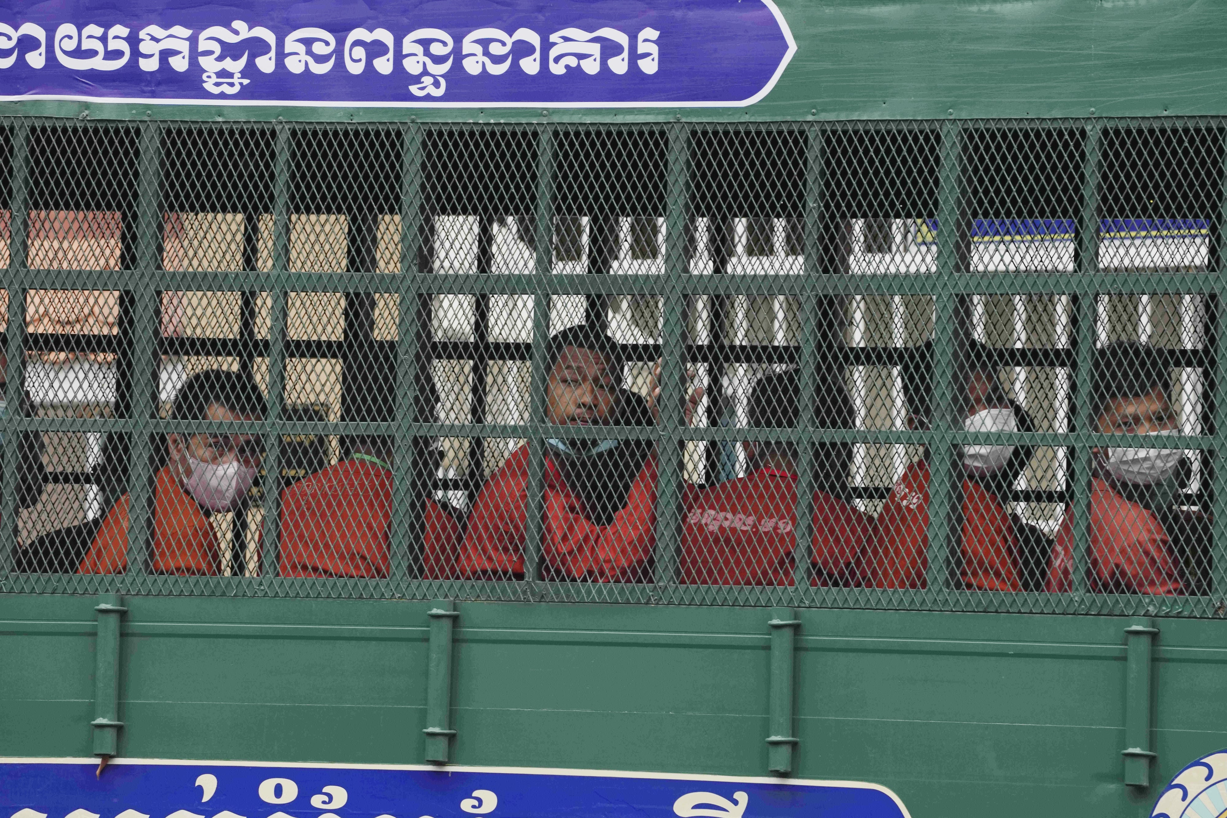 People on a prison truck arrive at the Municipal Court in Phnom Penh, Cambodia, March 17, 2022.