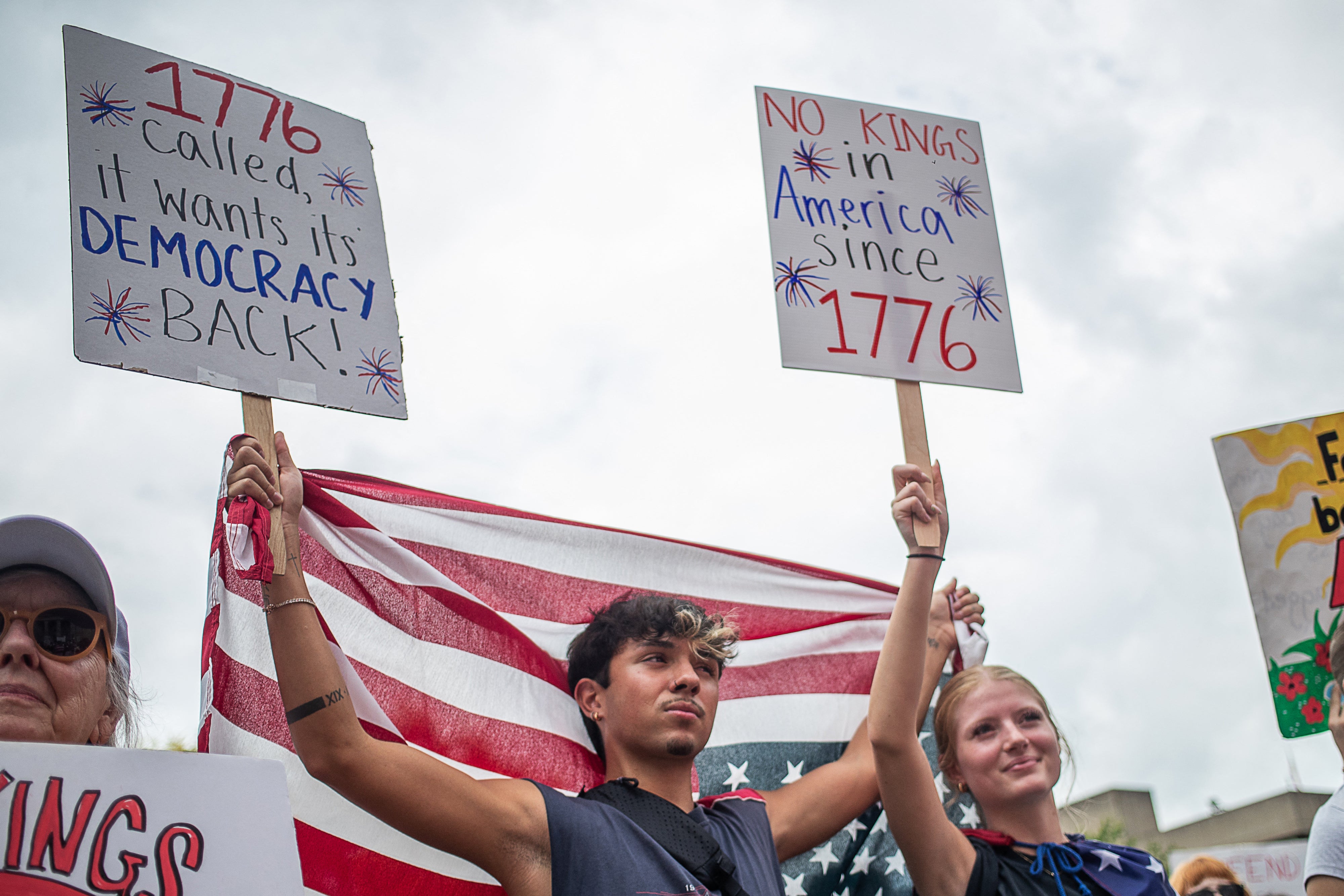 Protesters hold US flags and placards during a nationwide "No Kings" rally