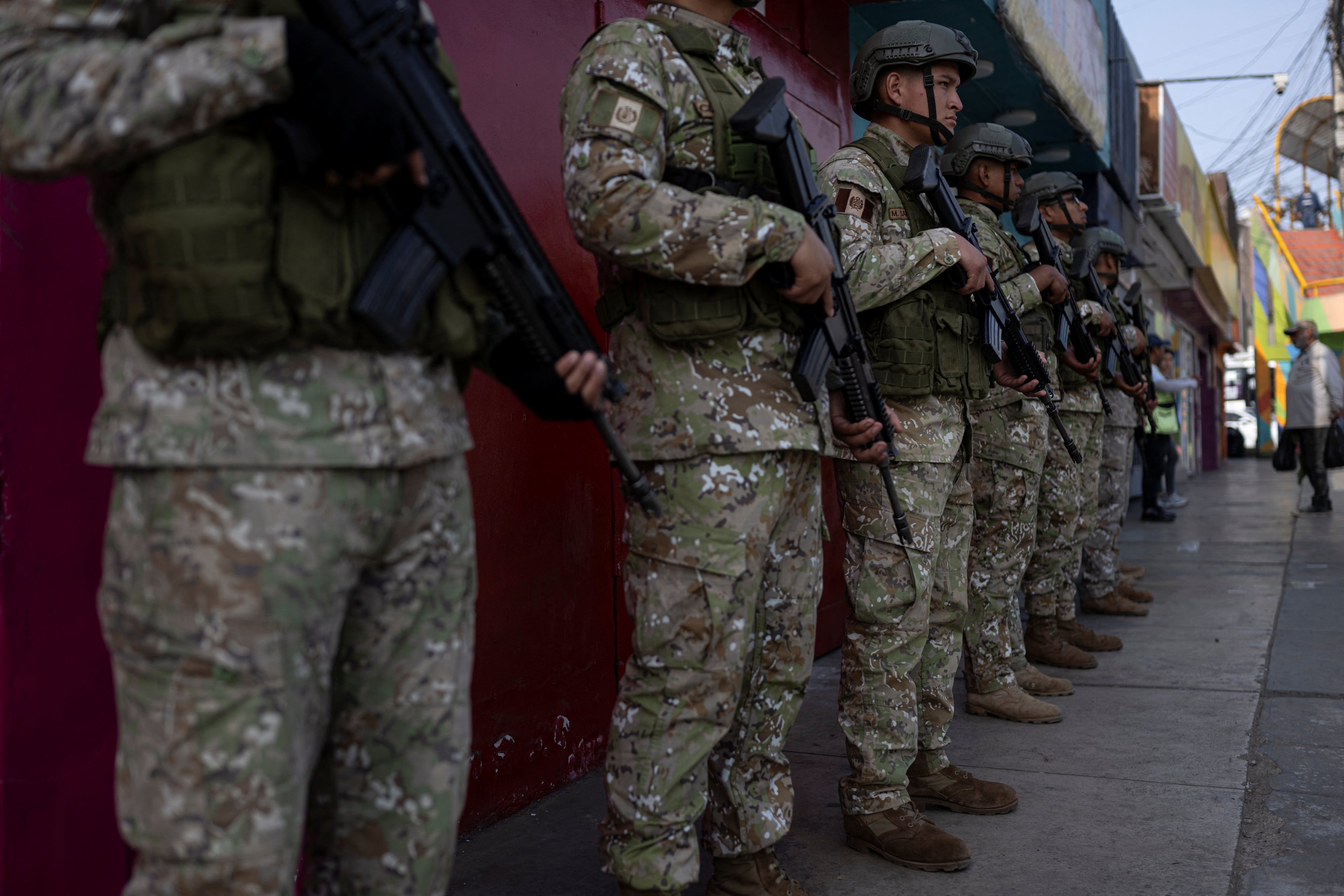 Military officers patrol a street after the government declared a state of emergency in Lima on October 22, 2025.