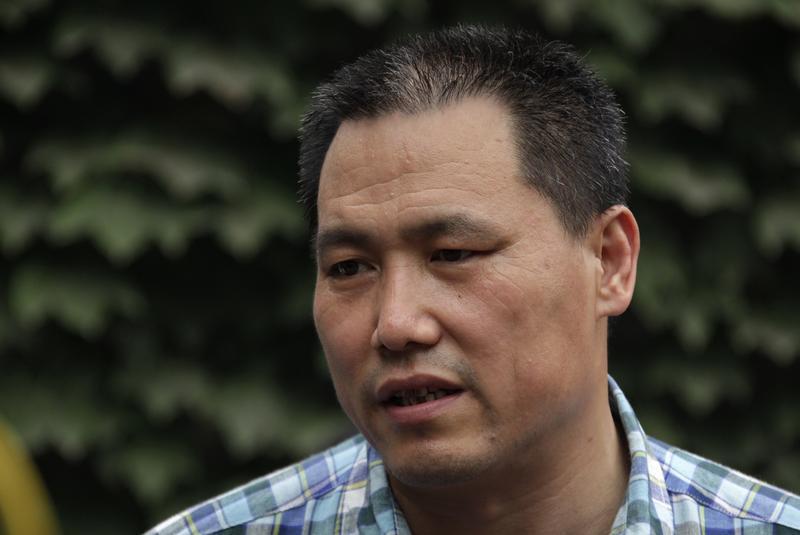 Chinese human rights lawyer Pu Zhiqiang talks to media in Beijing in this July 20, 2012 picture.