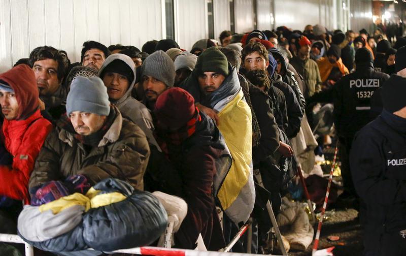 Migrants and asylum seekers wait to be registered outside the Berlin Office of Health and Social Affairs (LAGESO) in Germany, December 9, 2015.