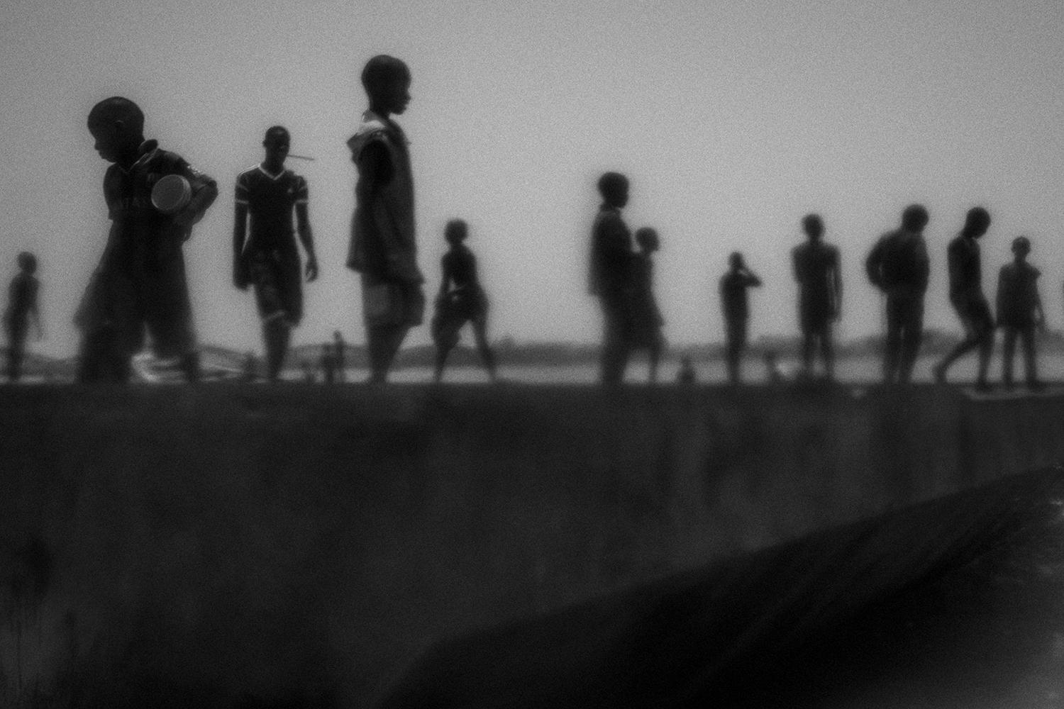Talibés who have run away from their Quranic schools stand on the banks of the Senegal River, in northern Senegal. 