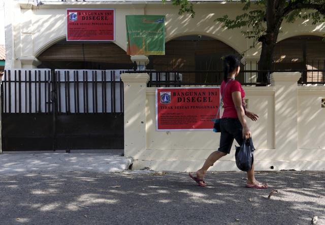 A sign on an Ahmadiyah mosque in South Jakarta, Indonesia reads, "This building is sealed due to inappropriate usage." The mosque was closed by government authorities in July 2015.