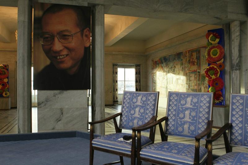 中国异见人士刘晓波的照片，在2010年12月10日诺贝尔和平奖颁奖仪式当天，悬挂在奥斯陆市政厅原该由他坐上的空椅旁边。