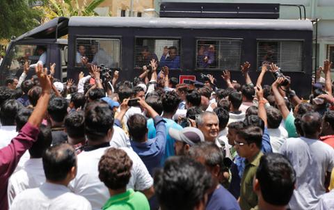 A police van transports some of those convicted in connection with the 2002 riots in Gujarat, India on June 2, 2016. 