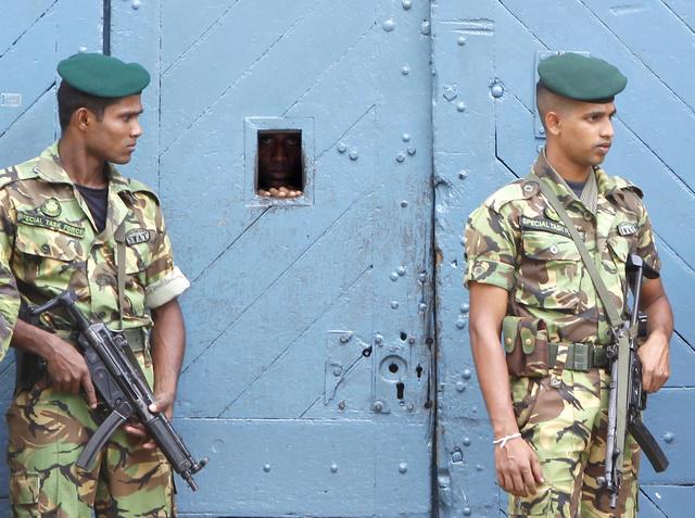 Special task force police officers stand guard outside a jail in Colombo on November 7, 2010.