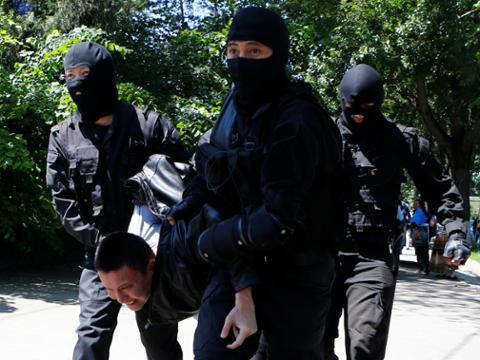 Riot police officers detain a demonstrator during a protest against an unpopular land reform proposal, in Almaty, Kazakhstan on May 21, 2016.