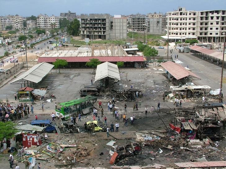 People inspect the damage after explosions hit the Syrian city of Tartous, in this handout picture provided by the Syrian Arab News Agency on May 23, 2016. 