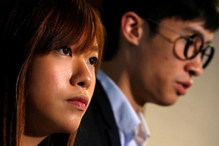 Pro-independence legislator elects Yau Wai-ching (L) and Baggio Leung react as they meet reporters inside Legislative Council in Hong Kong, China November 4, 2016. 