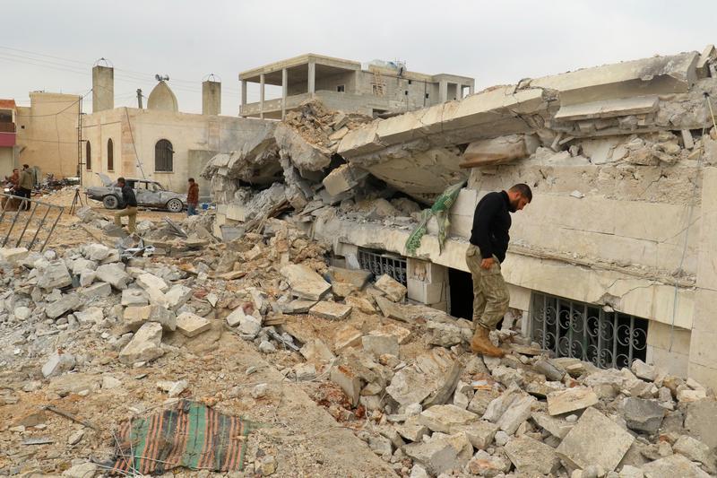 People inspect a damaged mosque after an airstrike on the rebel-held village of al-Jina, Aleppo province in northwest Syria March 17, 2017. 