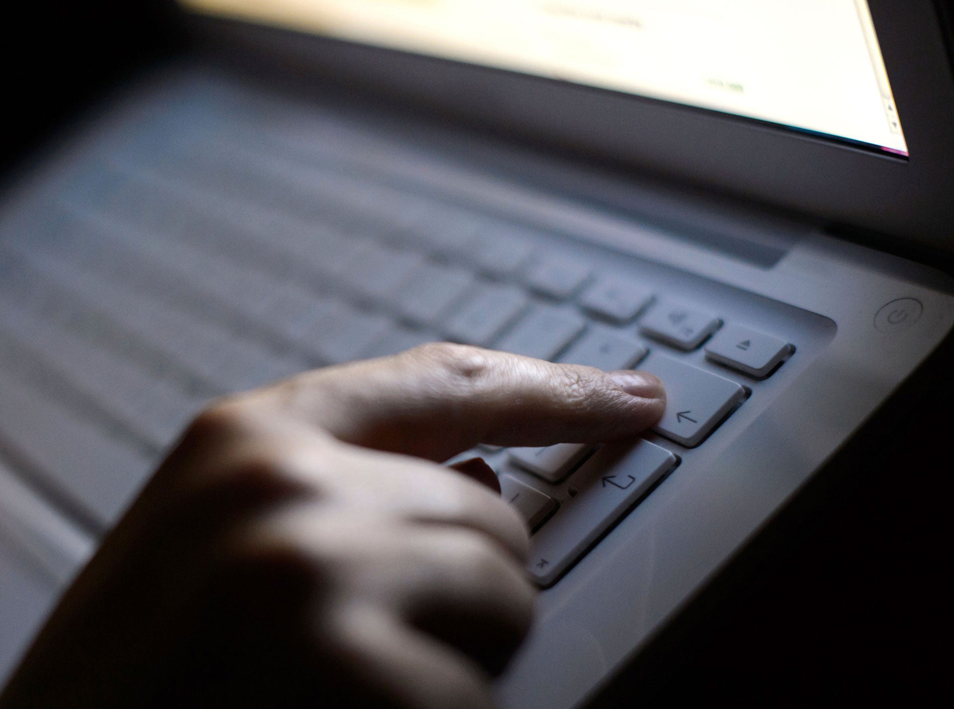 Someone uses a laptop for online research. 