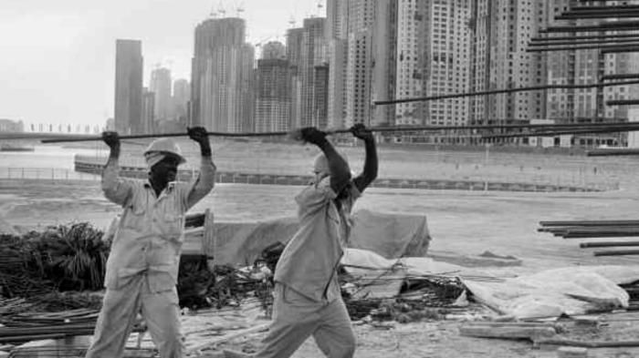 Foreign laborers work to build the Jumeirah Beach luxury apartment complex. 