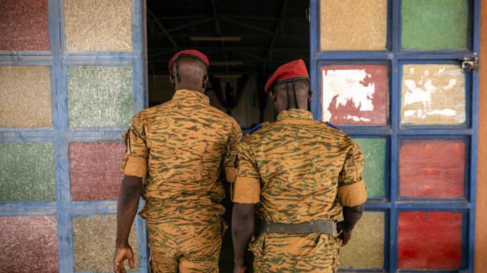 Two uniformed soldiers walk into a church