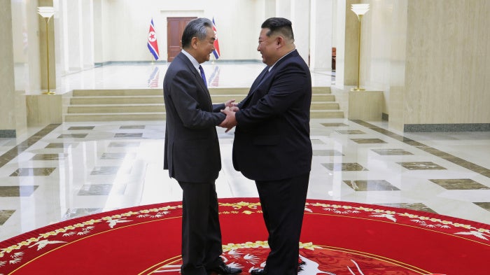 North Korean leader Kim Jong Un (right) greets Chinese Foreign Minister Wang Yi in Pyongyang, North Korea, on February 10, 2026.