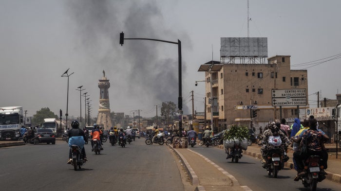 A column of black smoke rises above buildings in Bamako on April 26, 2026.