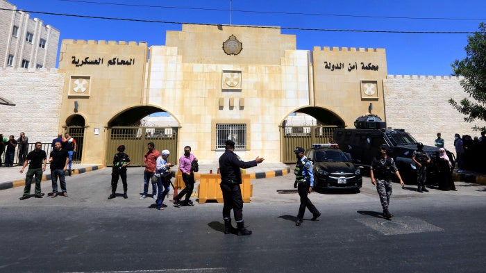 Security members stand guard outside the State Security Court in Amman, Jordan, July 12, 2021.