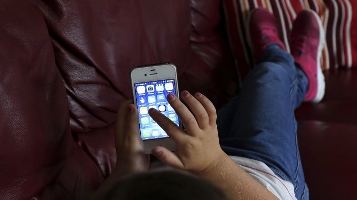 A child using a cellphone.