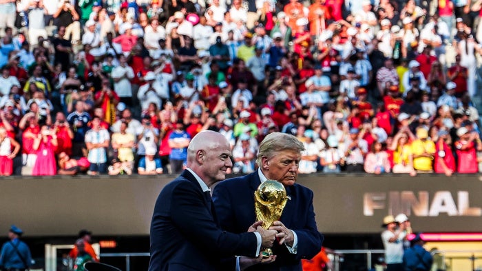 Infantino and Trump jointly holding the World Cup Trophy