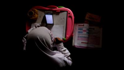 An overhead shot of a student on a cell phone