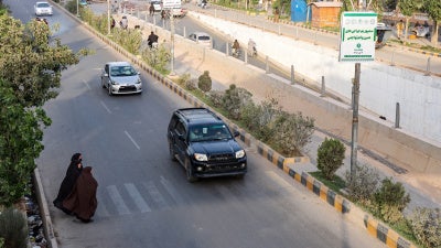 Afghan women walk across a street in Herat on June 8, 2026.