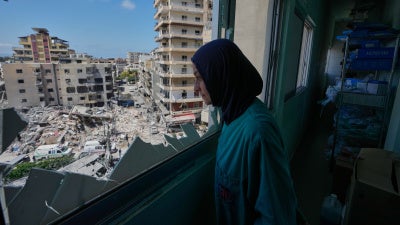 A nurse looks out of the Jabal Amel Hospital at areas struck during an Israeli airstrike in the southern port city of Tyre, Lebanon, June 2, 2026.