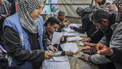 Palestinians receive humanitarian aid from the United Nations Relief and Works Agency for Palestine Refugees in the Near East (UNRWA) in Khan Younis, February 5, 2025. 
