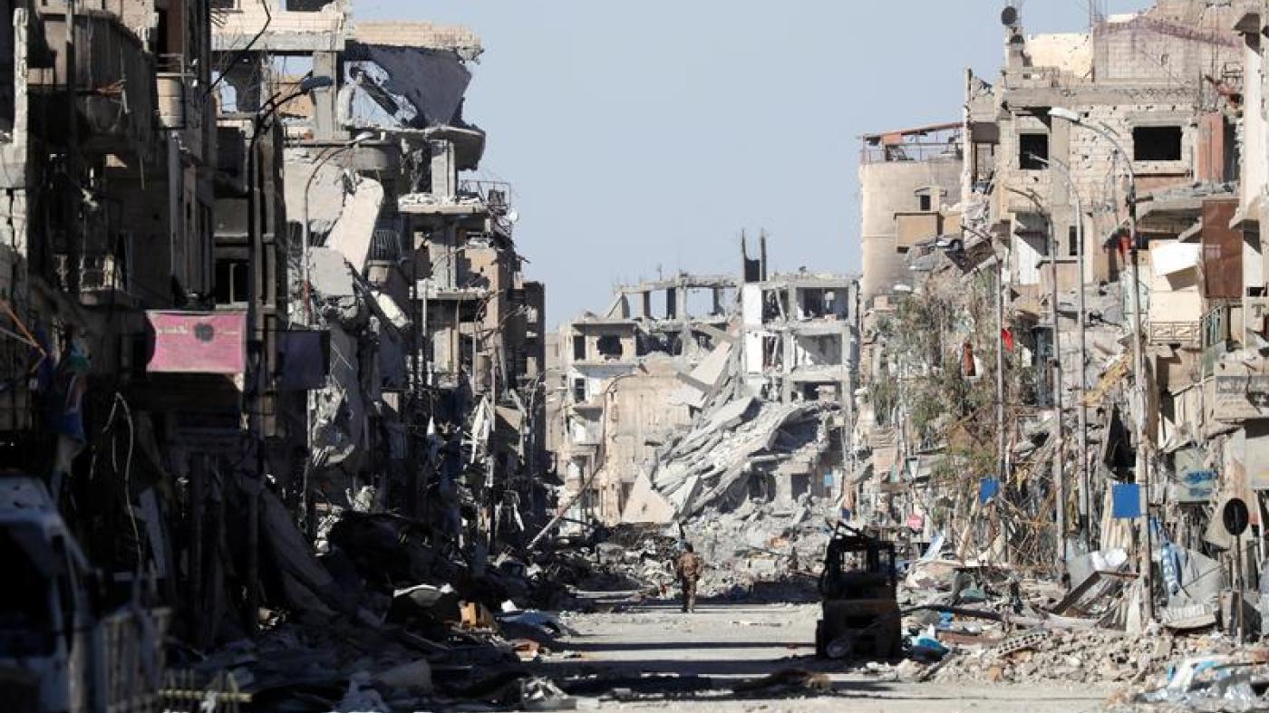 A fighter stands amidst the ruins of buildings near the Clock Square in Raqqa, Syria October 18, 2017. Picture taken October 18, 2017.
