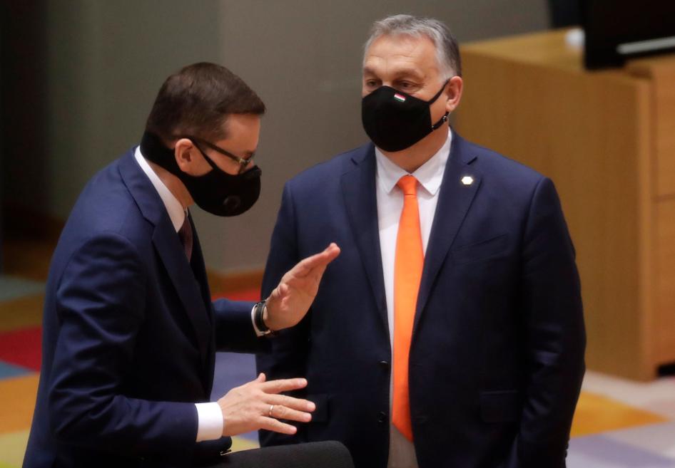 Poland's Prime Minister Mateusz Morawiecki, left, speaks with Hungary's Prime Minister Viktor Orban during a round table meeting at an EU summit at the European Council building in Brussels, December 10, 2020. 