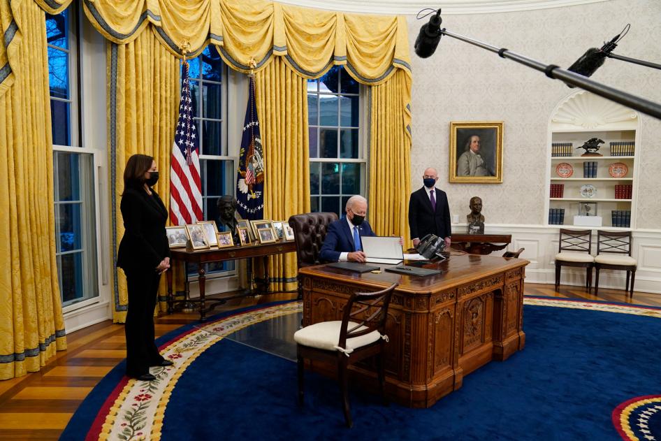 Vice President Kamala Harris, left, and Secretary of Homeland Security Alejandro Mayorkas, right, watch as President Joe Biden signs an executive order on immigration in the Oval Office of the White House in Washington, February 2, 2021.