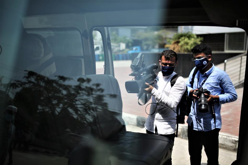 Journalists work in front of a Covid-19 Hospital in Dhaka, Bangladesh on April 20, 2021. 
