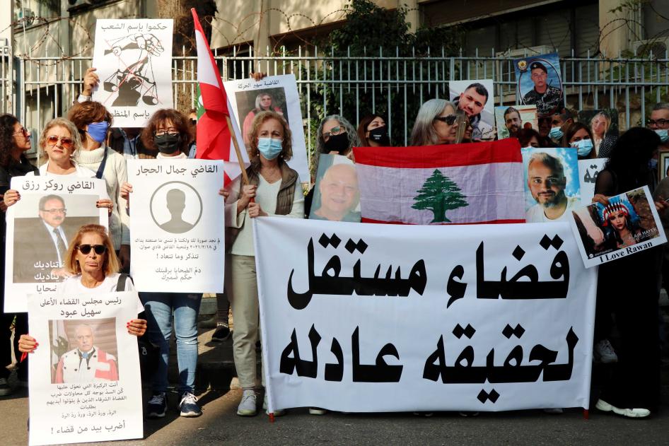 Families of Port Blast's victims show portraits of their beloved ones near the Palace of Justice in Beirut, November 25, 2021. Relatives of victims call for an independent judiciary to achieve justice.