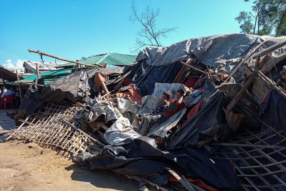 Rohingya refugees lie on a razed shop demolished by authorities in the Kutupalong camp in Ukhia, Bangladesh, December 10, 2021. 