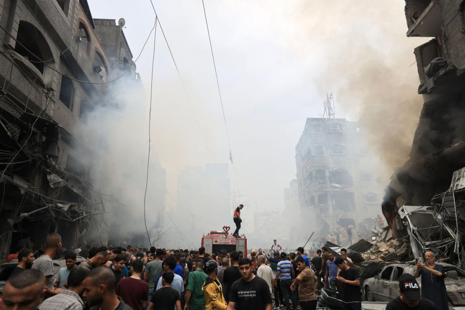 Palestinians search for survivors after an airstrike on buildings in the refugee camp of Jabalia in the Gaza Strip on October 9, 2023. 