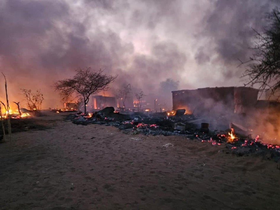Houses on fire, southwest of Abu Shouk camp.