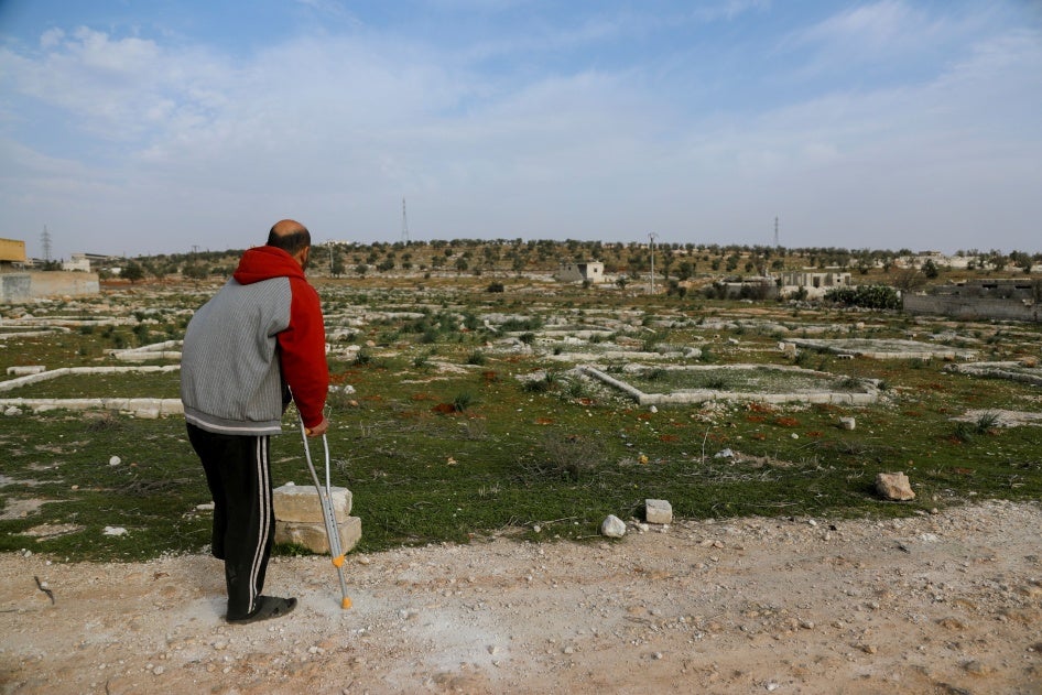 Nidal Ahmad stands near his olive farm in Aleppo, Syria on March 4, 2025. Its location near a former Syrian Army military camp has prevented him from harvesting crops for years. Last December, Nidal returned to check on his land and lost his foot in a landmine explosion. 