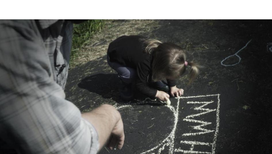 A father plays with his daughter, who was born with atypical sex characteristics. Despite pressure from doctors, the parents chose not to elect medically unnecessary surgeries on their child. 