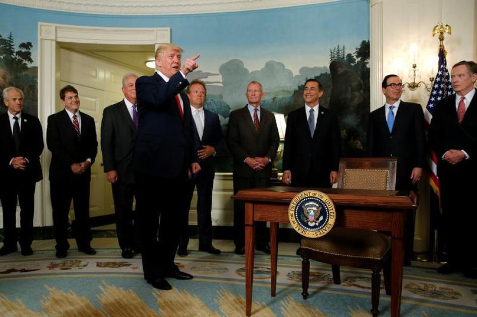 U.S. President Donald Trump accuses a CNN reporter of being "fake news" after signing a memorandum directing the U.S. Trade Representative to complete a review of trade issues with China at the White House in Washington, U.S. August 14, 2017.