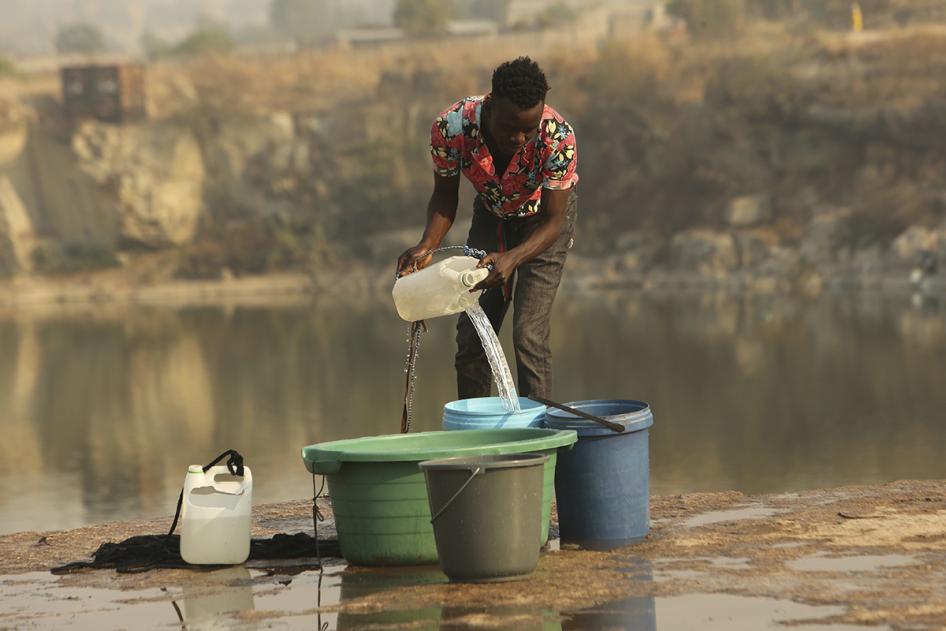 A man fetches water from a disused quarry in Harare, October 1, 2019. 